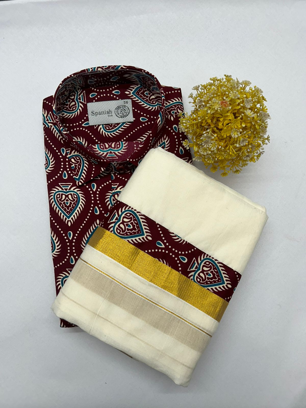 Folded fabric with maroon and cream patterns on a white background