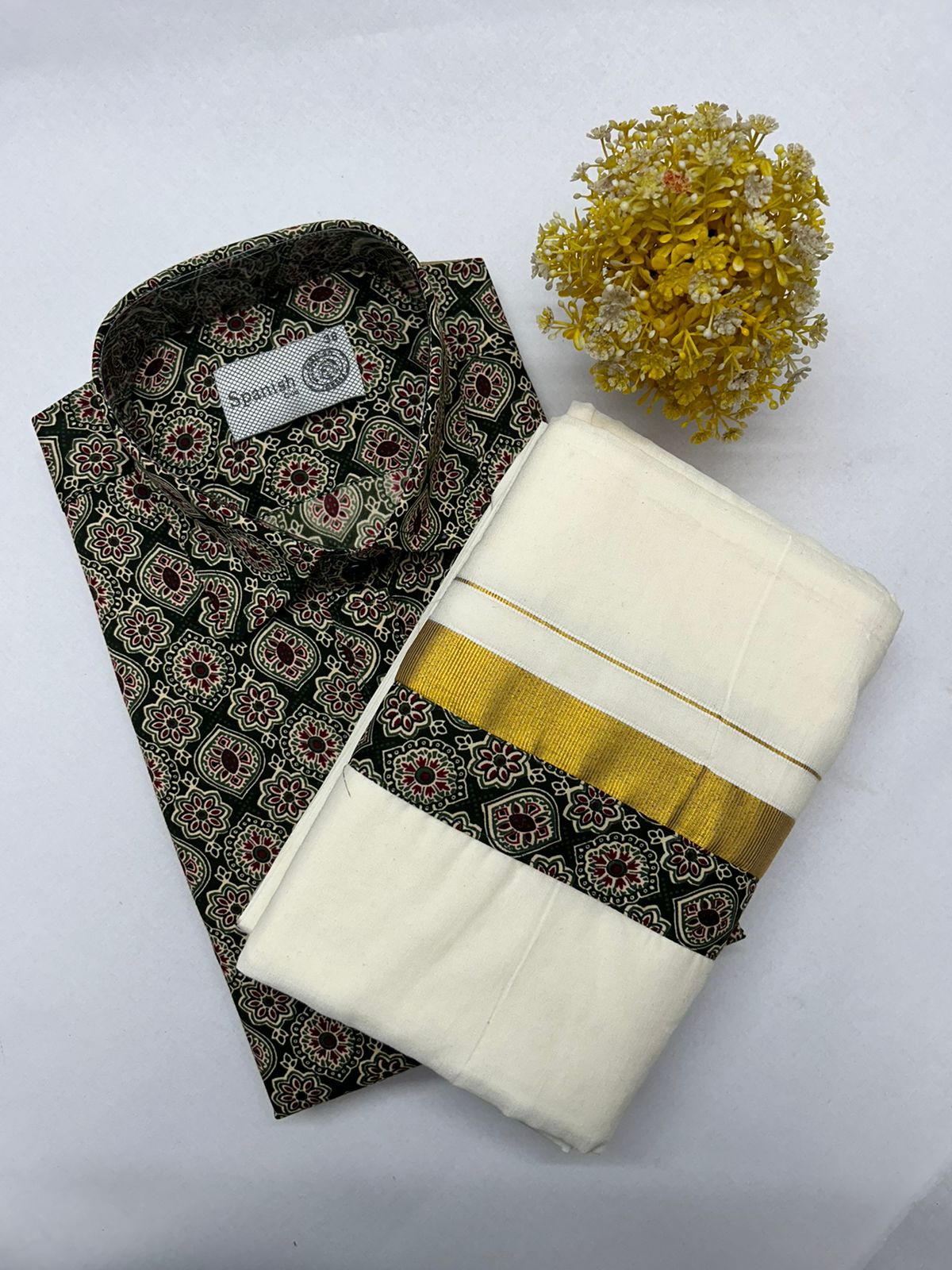 Folded patterned shirt with a matching folded fabric on a white background