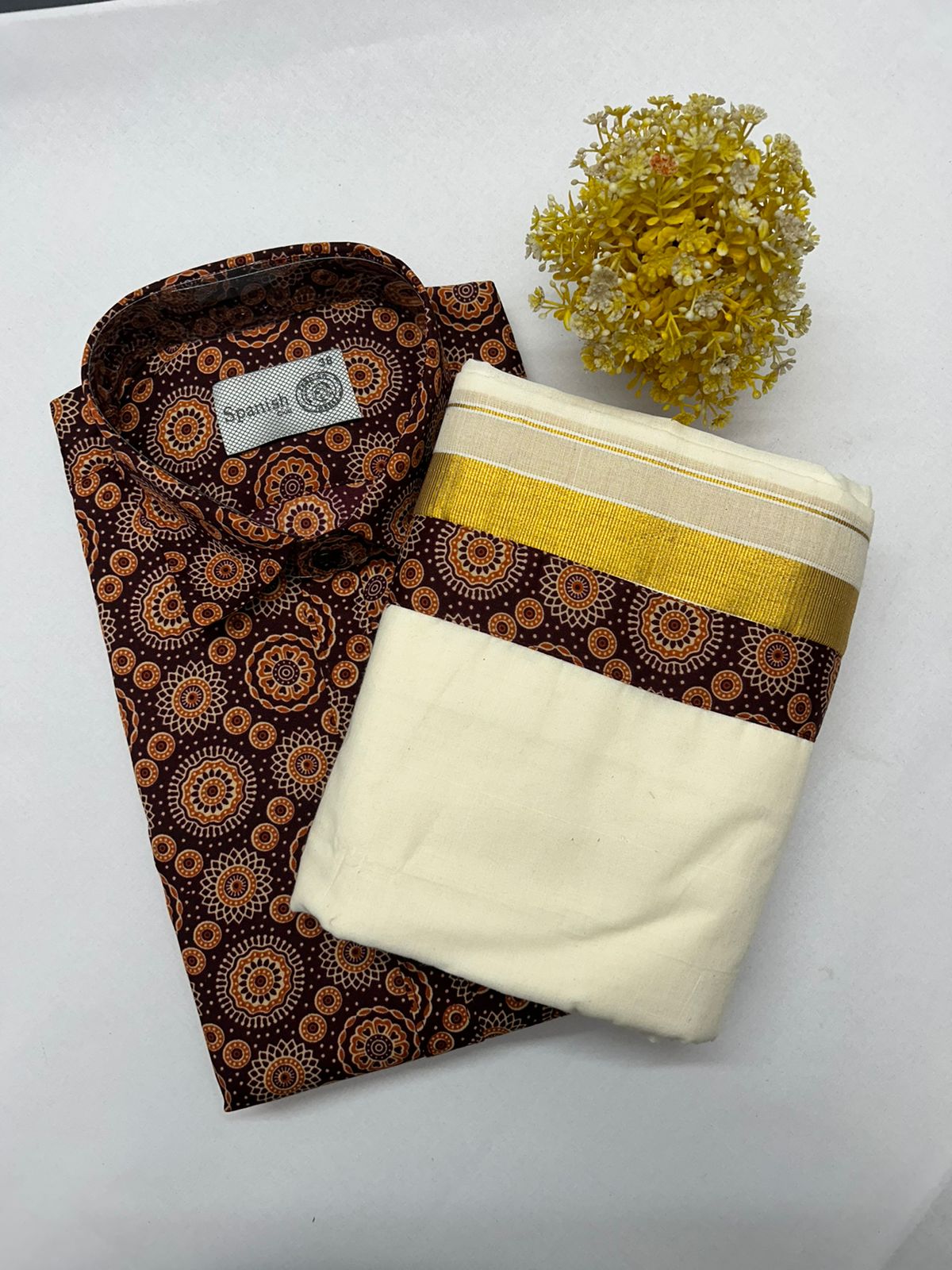 Folded patterned fabric with a plain white fabric on a white background