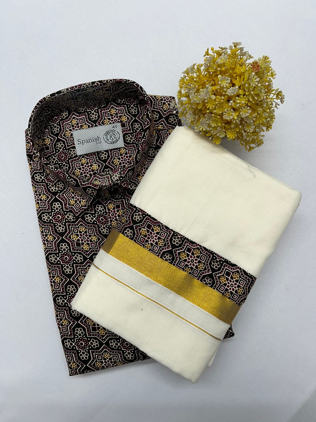 Traditional fabric with a pattern and a plain white fabric with a yellow band on a light gray background.