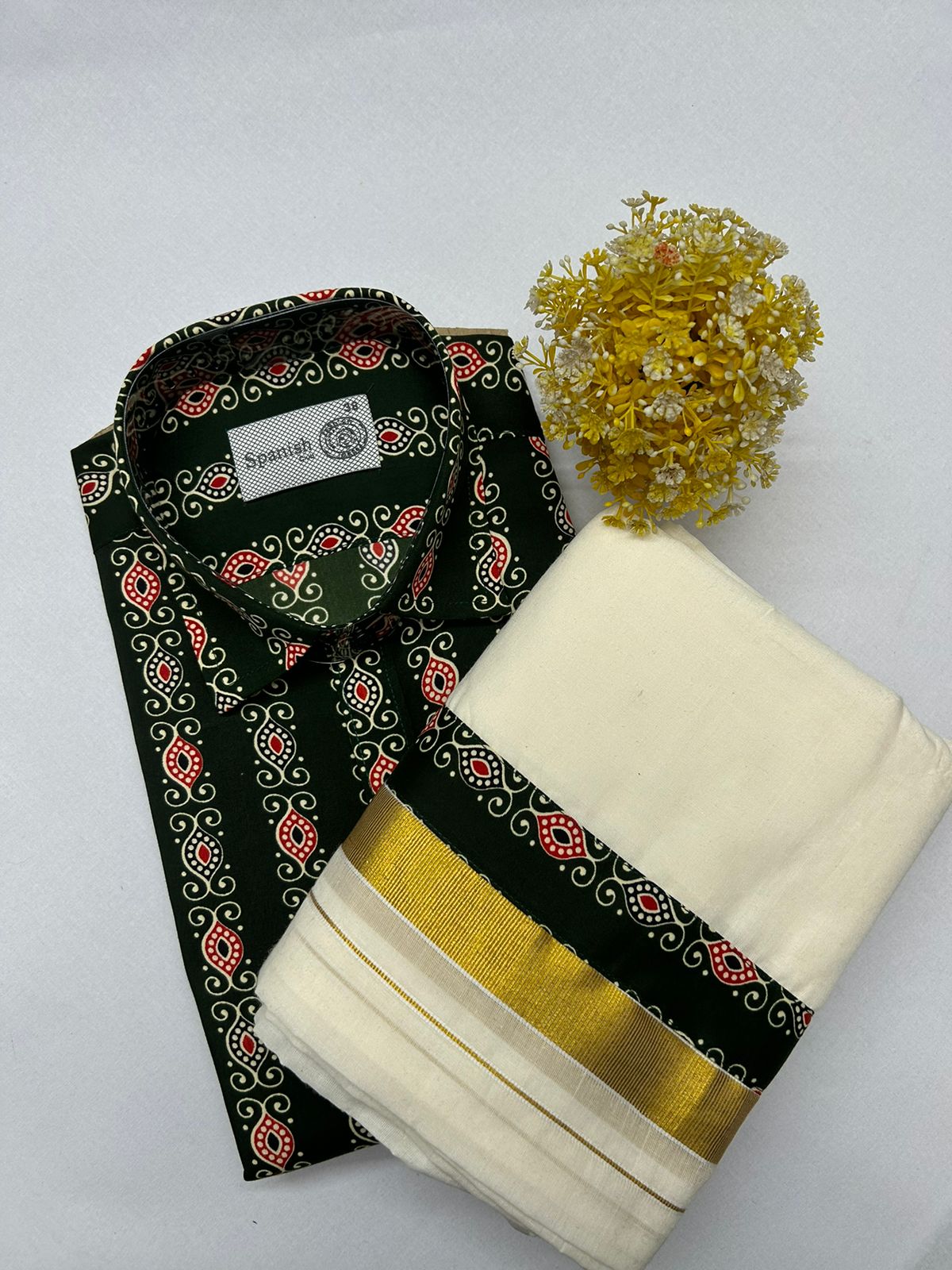 Black and white patterned shirt with a yellow flower on a light gray background