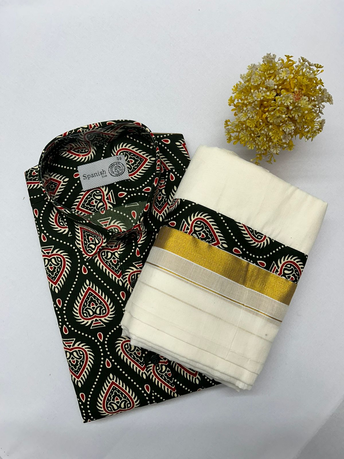 Folded black and white patterned fabric with a yellow stripe on a white background