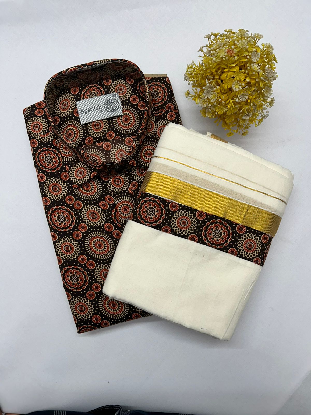 Two folded fabric items with a decorative pattern on a white background